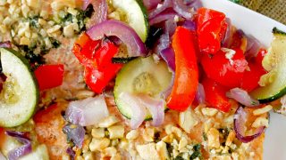 Pstrąg tęczowy pieczony z warzywami i masłem czosnkowym